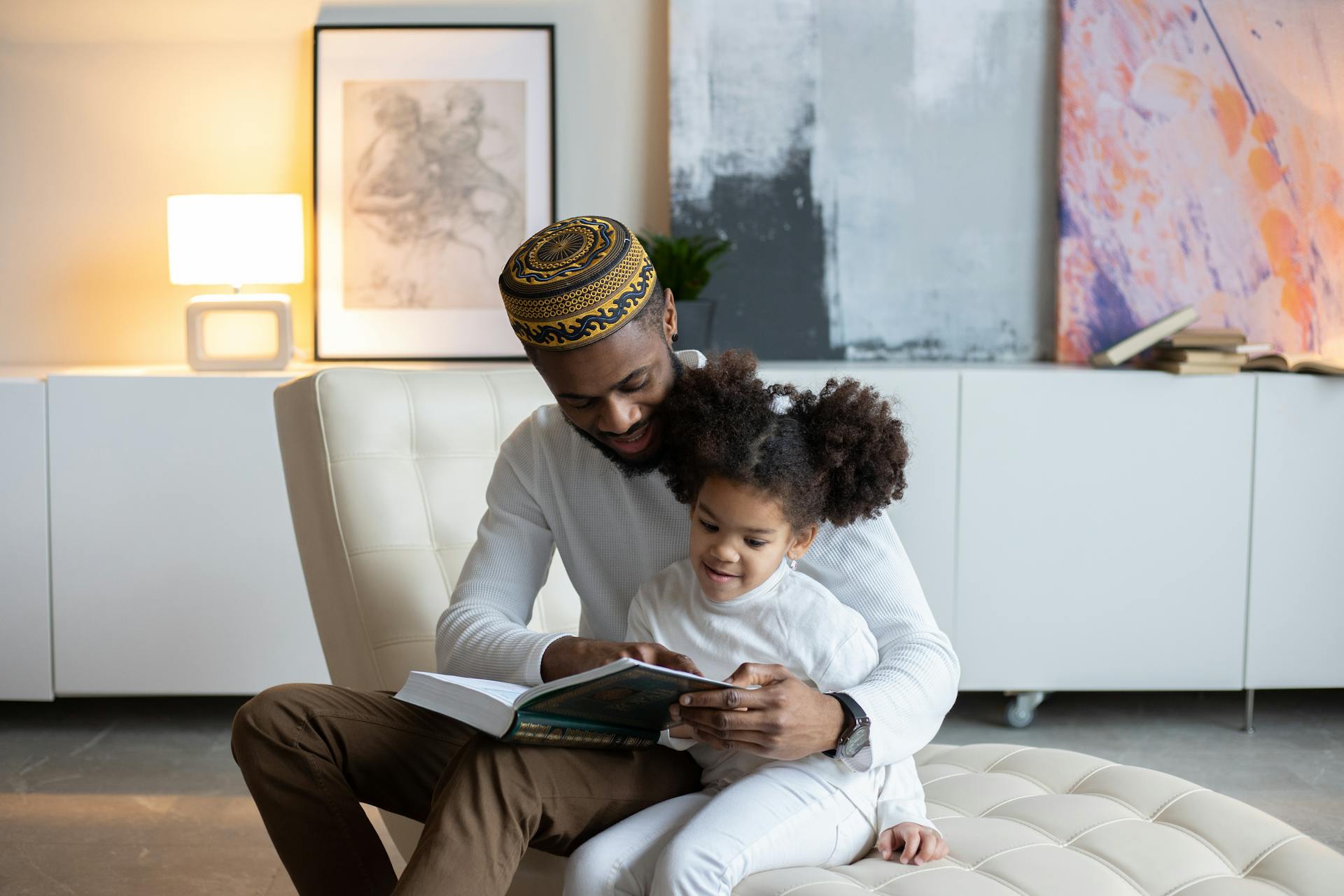 A parent holding their child reading a book